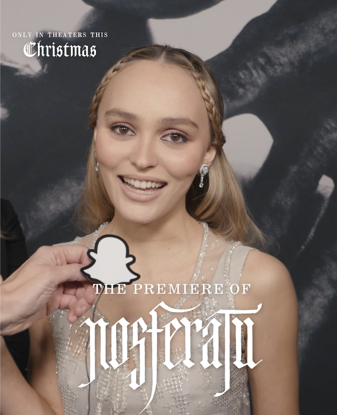Lily-Rose Depp at the Nosferatu premiere holding a Snapchat logo